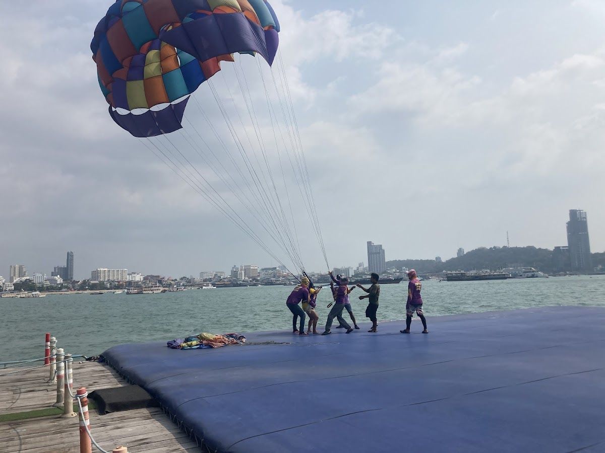 Parasailing over Pattaya Bay with city skyline in background