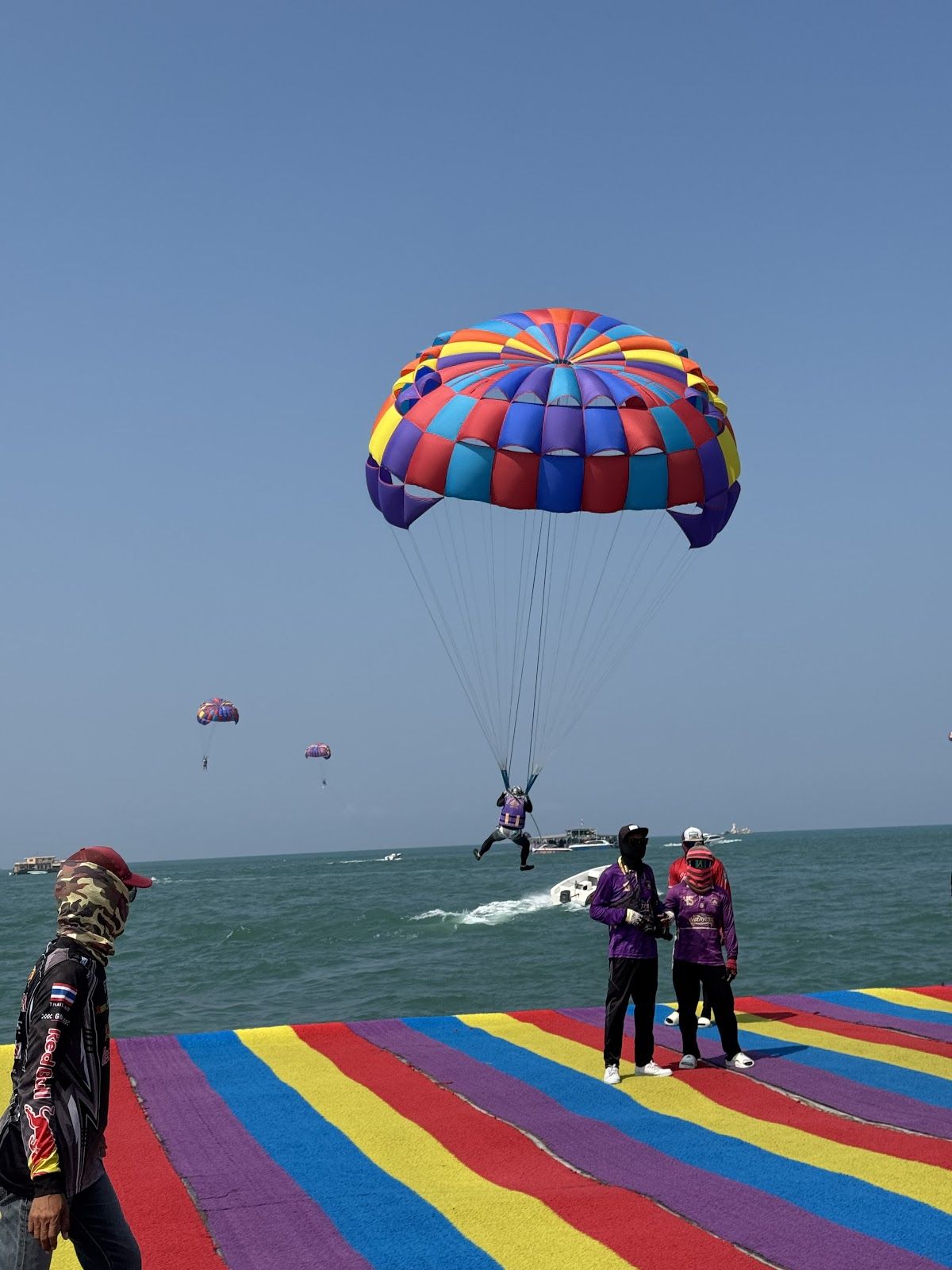 Parasailing over Pattaya Bay with the city skyline in the background