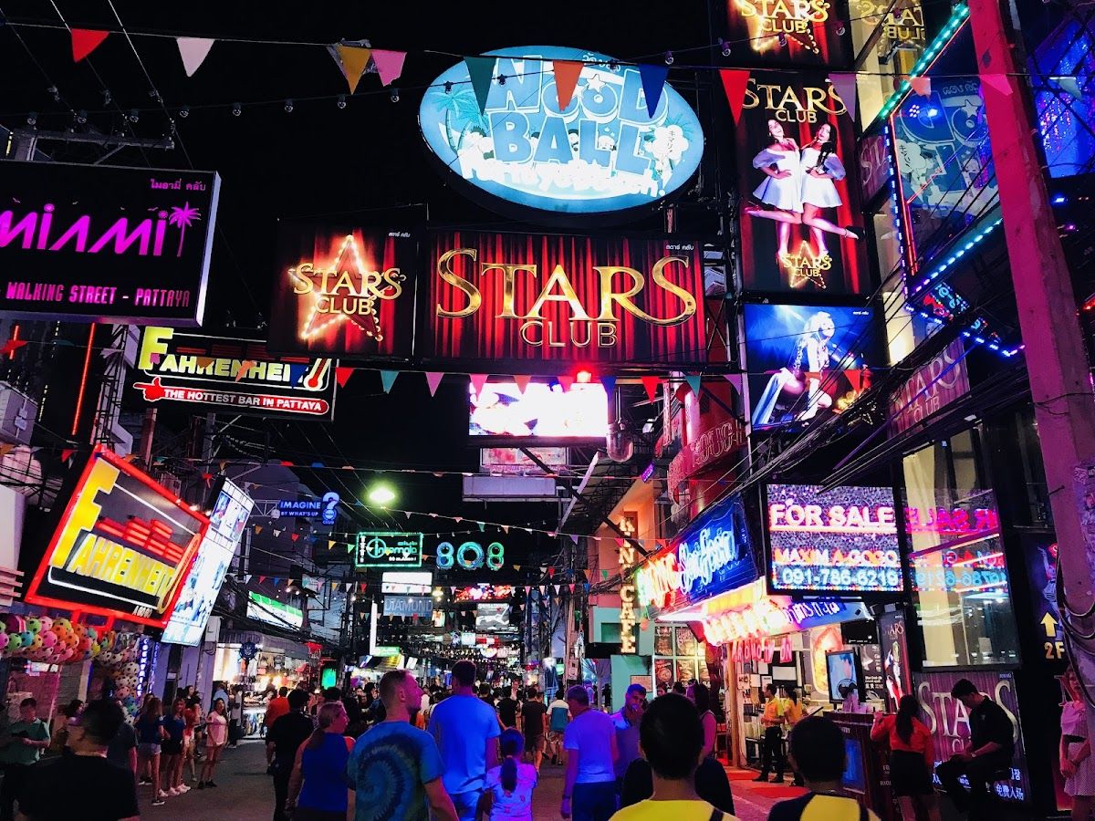 Pattaya Walking Street at night with neon lights and crowds along Beach Road